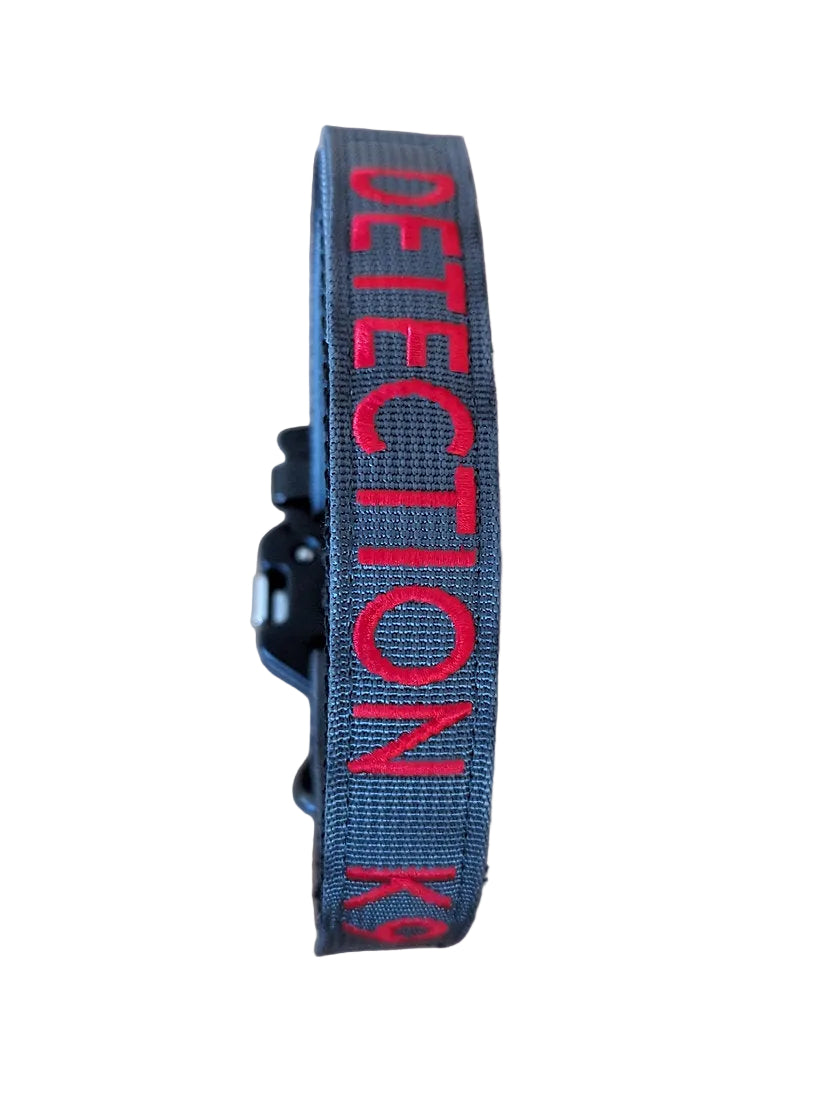 Gray dog collar with 'DETECTION K9' text on a white background